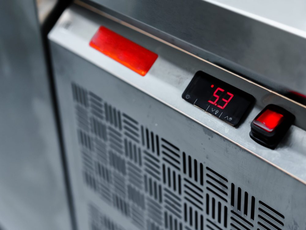 Commercial kitchen appliance temperature controls close up photo